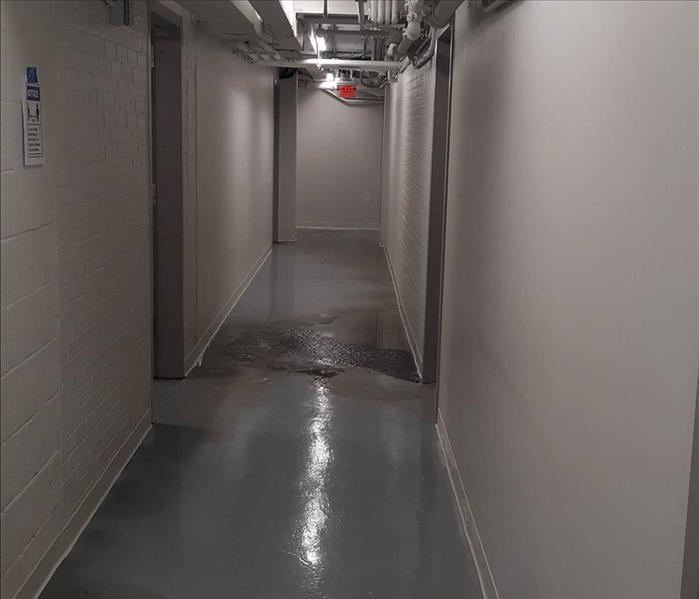 water damage on a floor in a hallway of a church