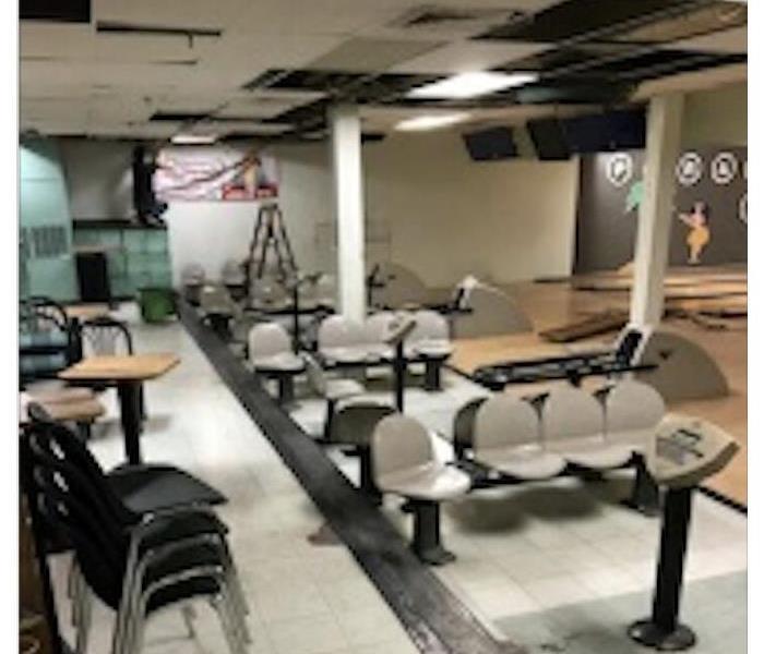 Bowling alley with ceiling and floor damage.
