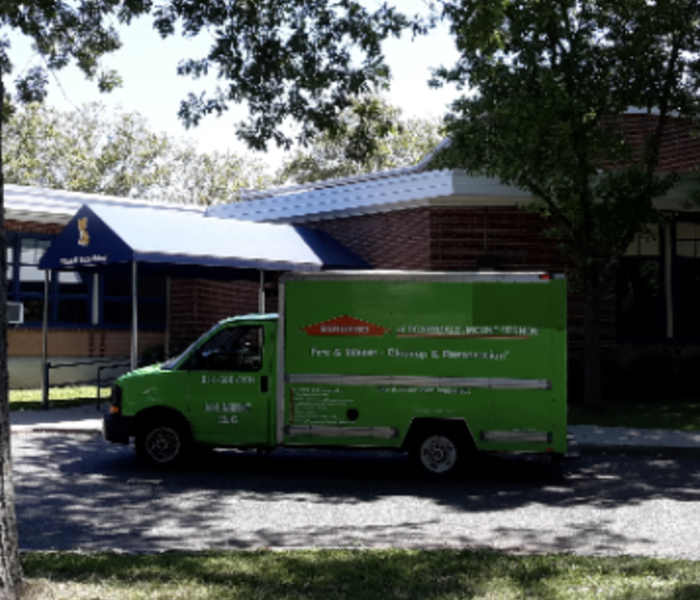 SERVPRO truck parked outside home.