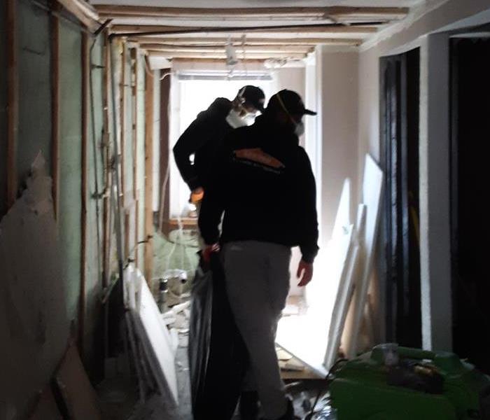 the first floor of a house under demolition with two men inside