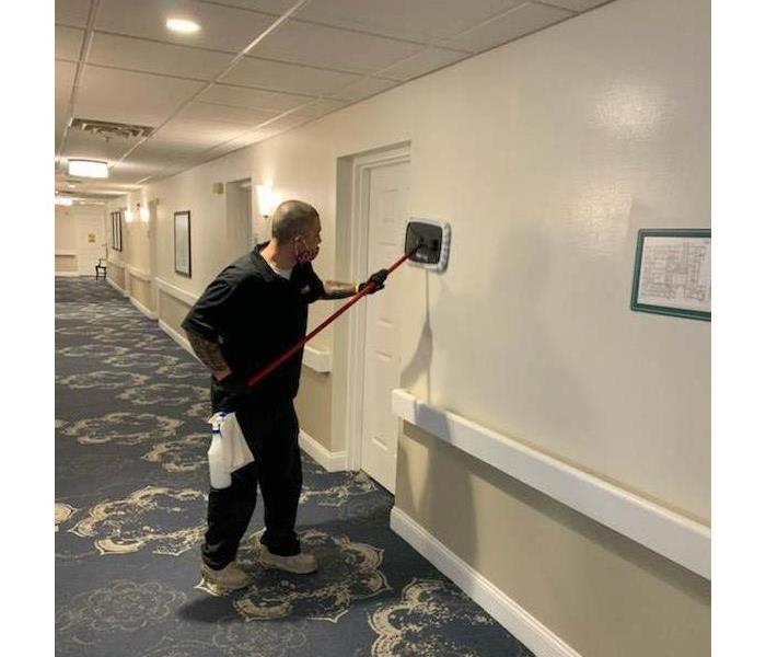 SERVPRO employee cleaning a commercial building