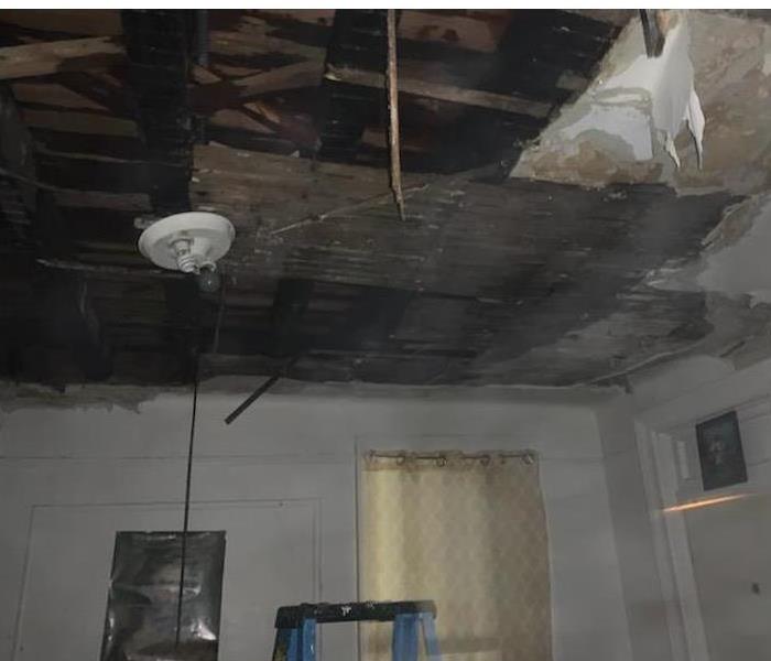 Fire damaged ceiling and walls.