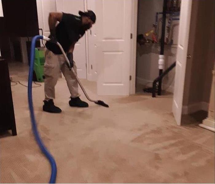 A specialist is extracting water damage from a house.