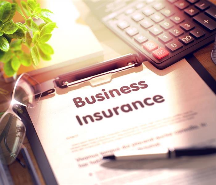Business Insurance. Business Concept on Clipboard. Composition with Clipboard, Calculator, Glasses, Green Flower and Office S