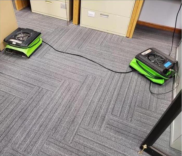 two air movers placed on the floor of an office