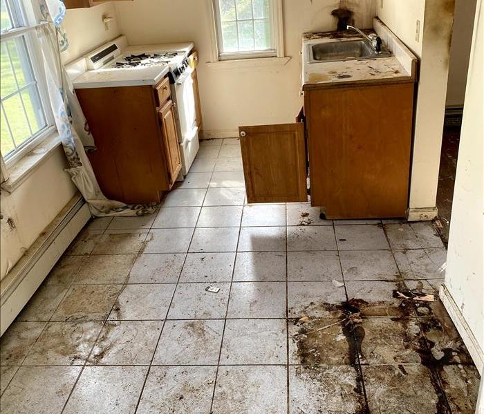 a kitchen with dirty floors